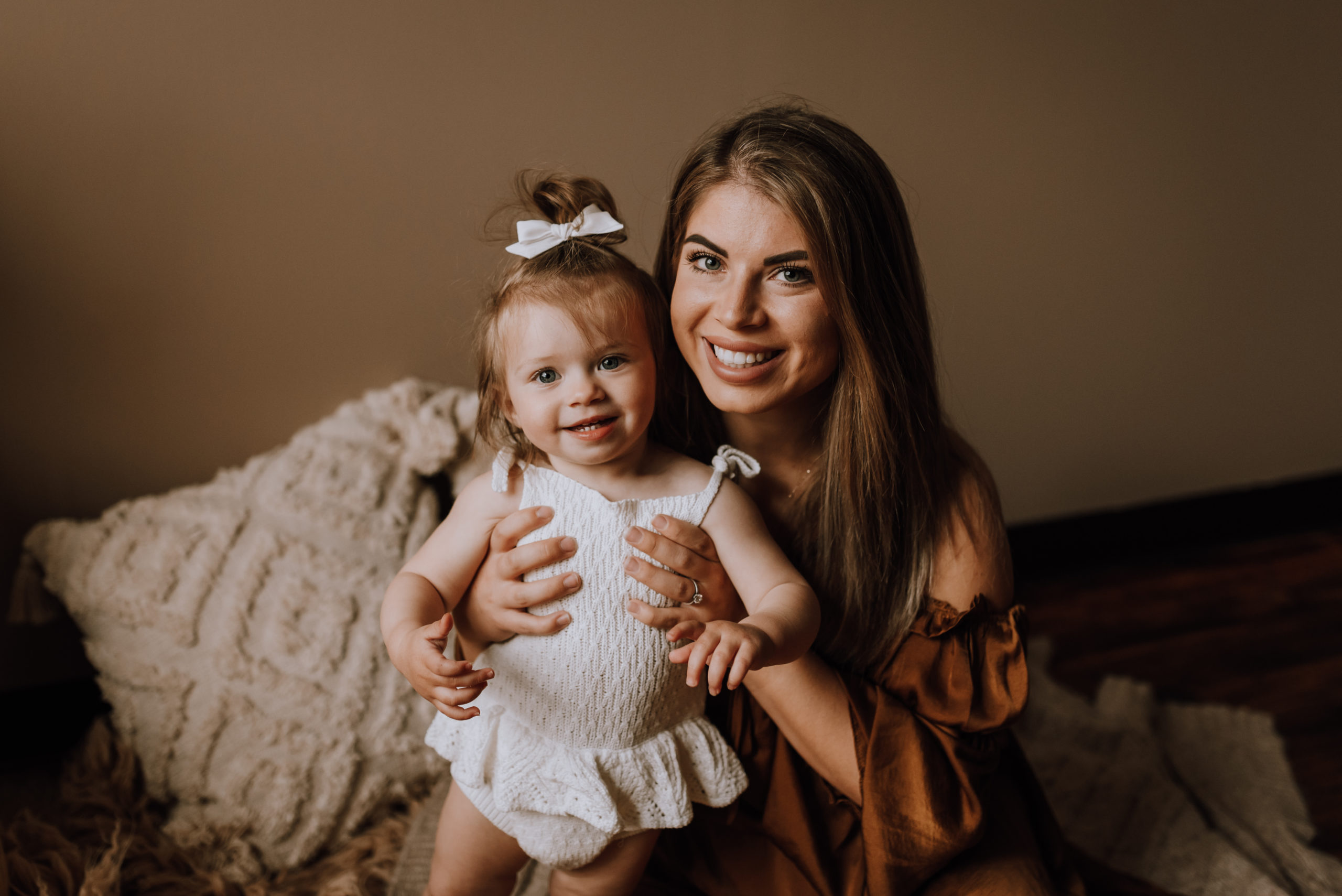 mom holding little girl and smiling hair salons in hamilton
