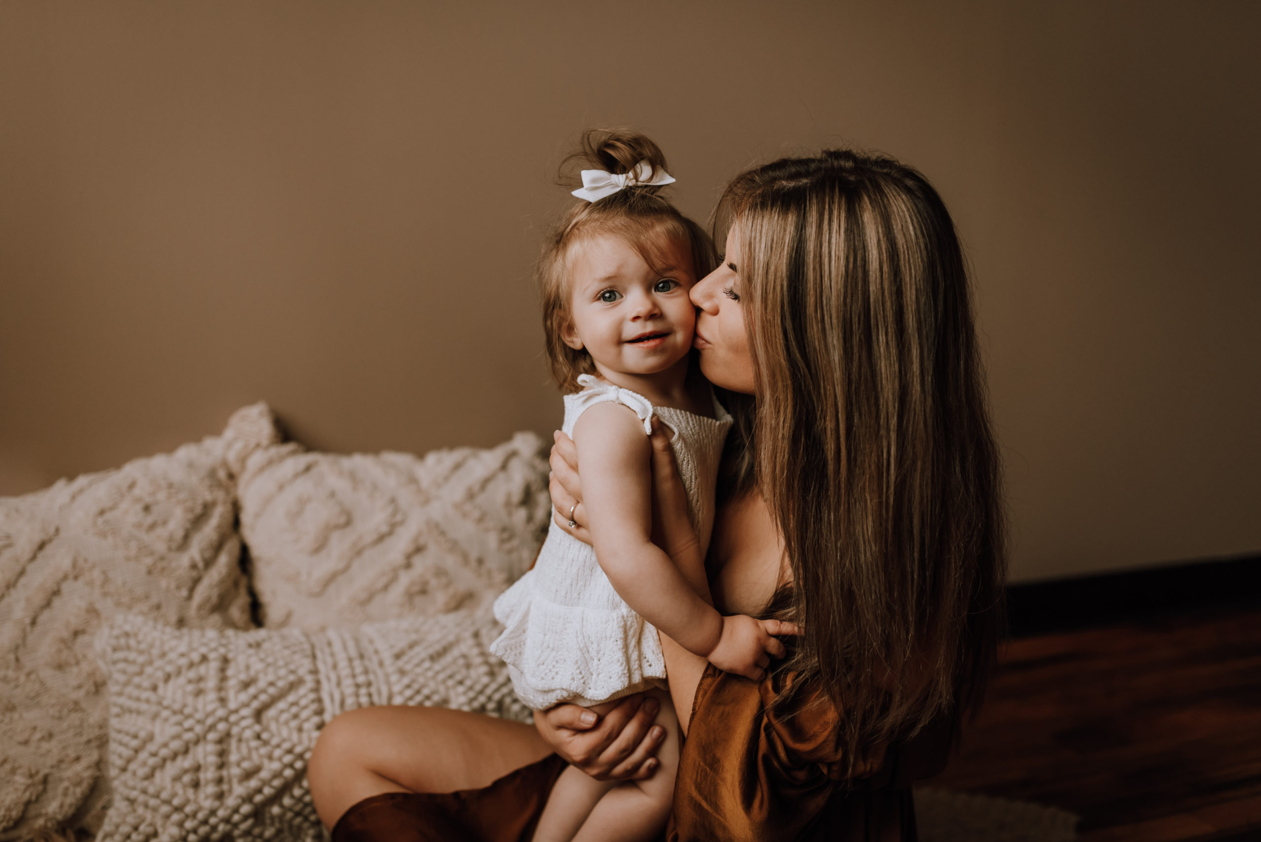 mom kissing daughter on the cheek hair salons in hamilton